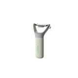 Handheld vegetable peeler with a light green handle and gray blade assembly.
