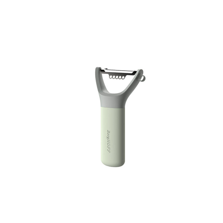Handheld vegetable peeler with a light green handle and gray blade assembly.