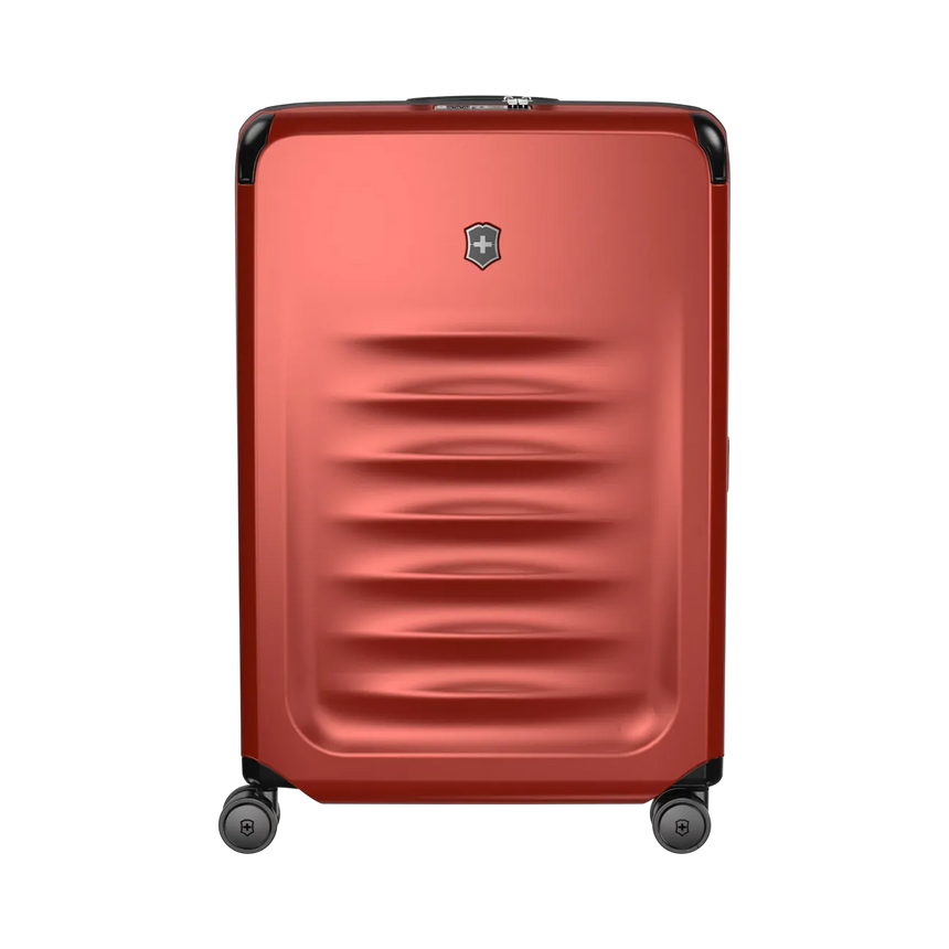 Red hardshell rolling suitcase with horizontal ridges and a logo emblem.