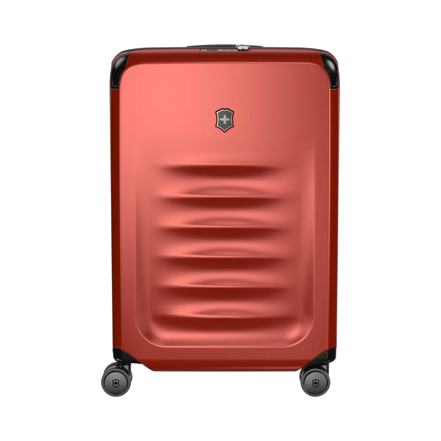 Red hardshell rolling suitcase with horizontal ridges and a logo emblem.