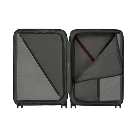 Open hard-shell suitcase with interior compartments and zippered sections.