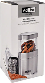 Mini chili and spice grinder with a clear container showing whole spices inside.