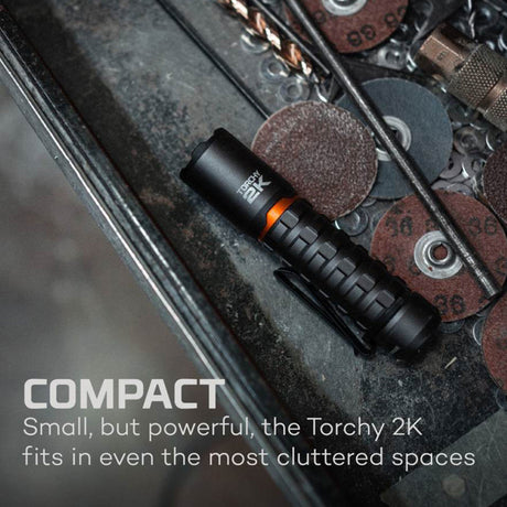 Black cylindrical flashlight with textured grip and orange accents.