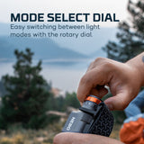Handheld flashlight with a rotary dial for selecting different light modes.