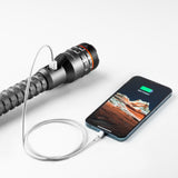 Handheld device with a cylindrical body and multiple colored rings, connected by a cable to a smartphone.