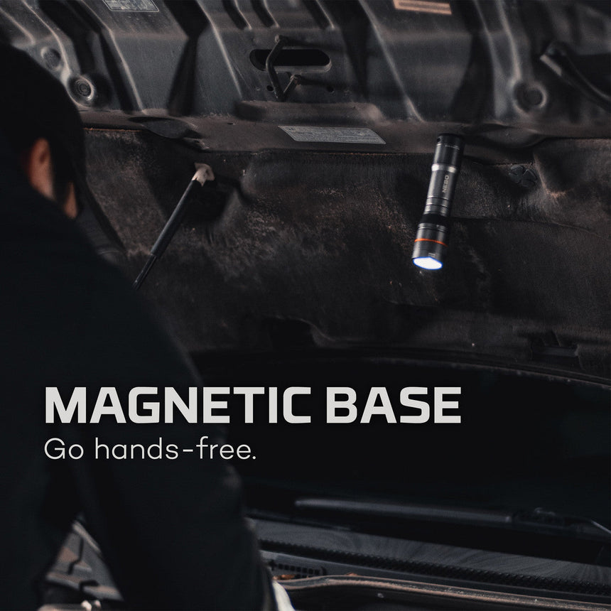 Magnetic flashlight attached to the underside of a vehicle.