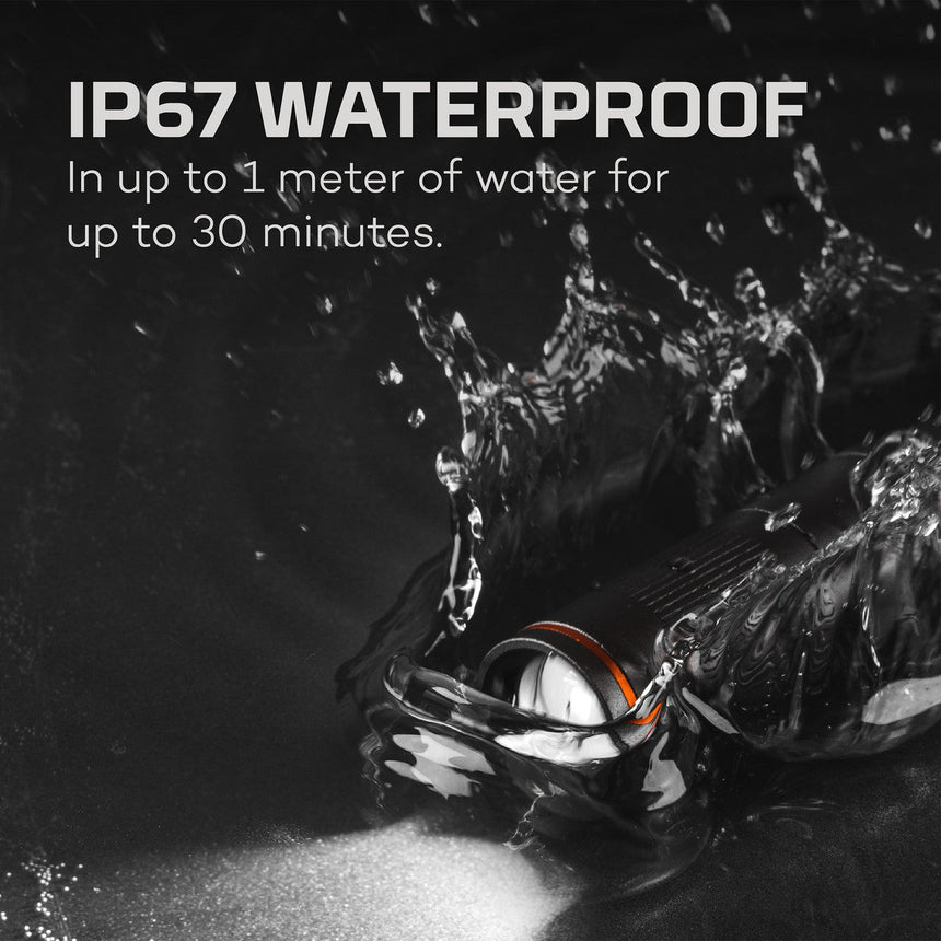 Waterproof electronic device or smartwatch submerged in water with splashes around it.