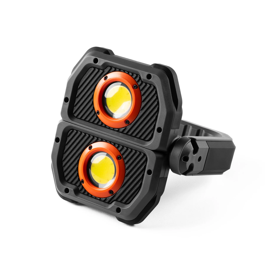 Dual-headed LED work light with orange and yellow illuminated lenses in a black housing.
