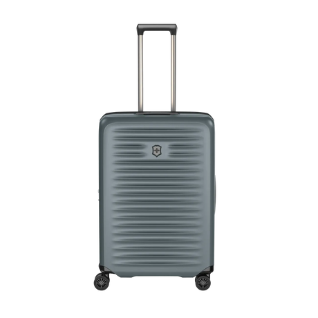 Gray hardshell rolling suitcase with horizontal ridges and an extendable handle.
