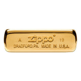 Gold-plated Zippo lighter bottom with engraved text.