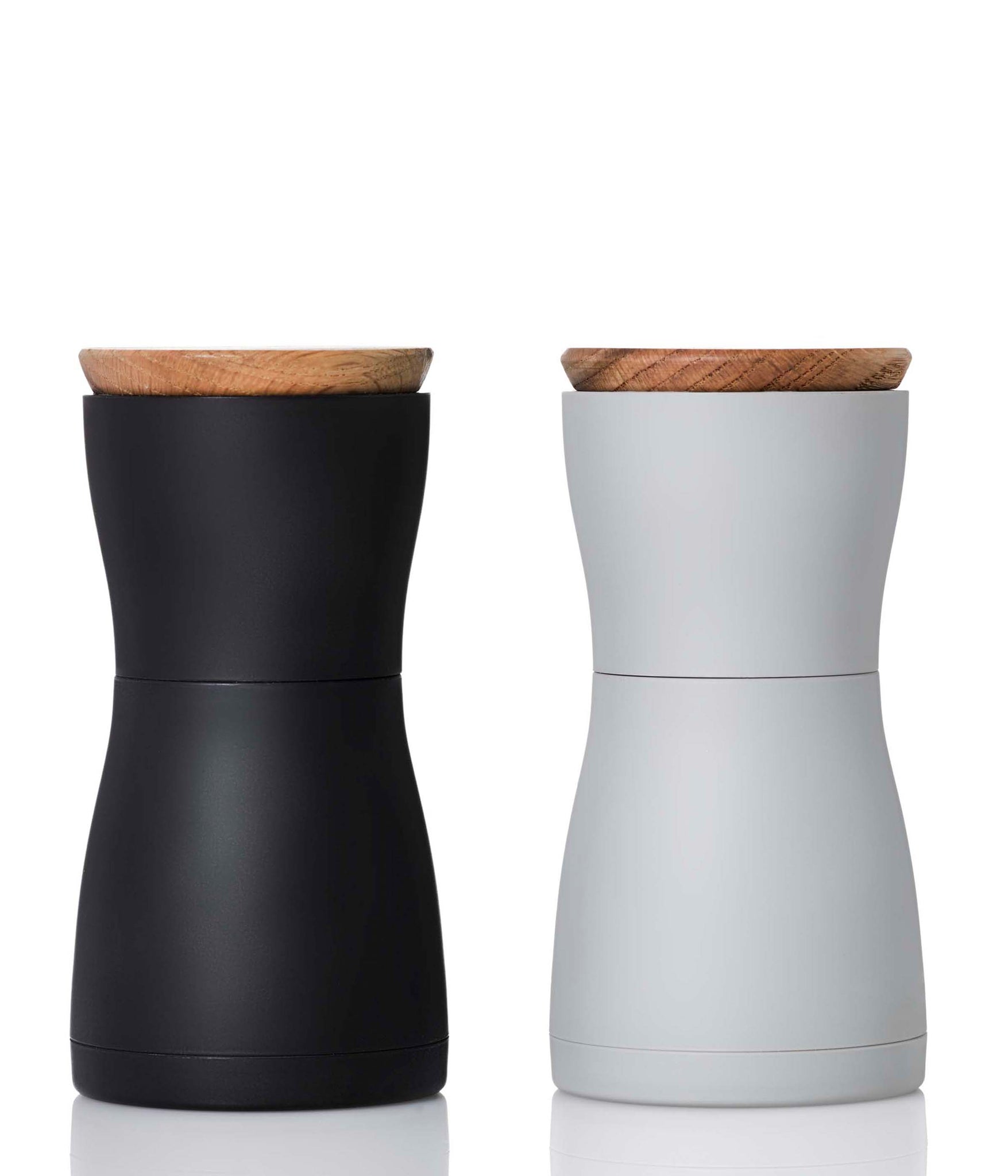 Salt and pepper grinder set with wooden lids in black and white colors.