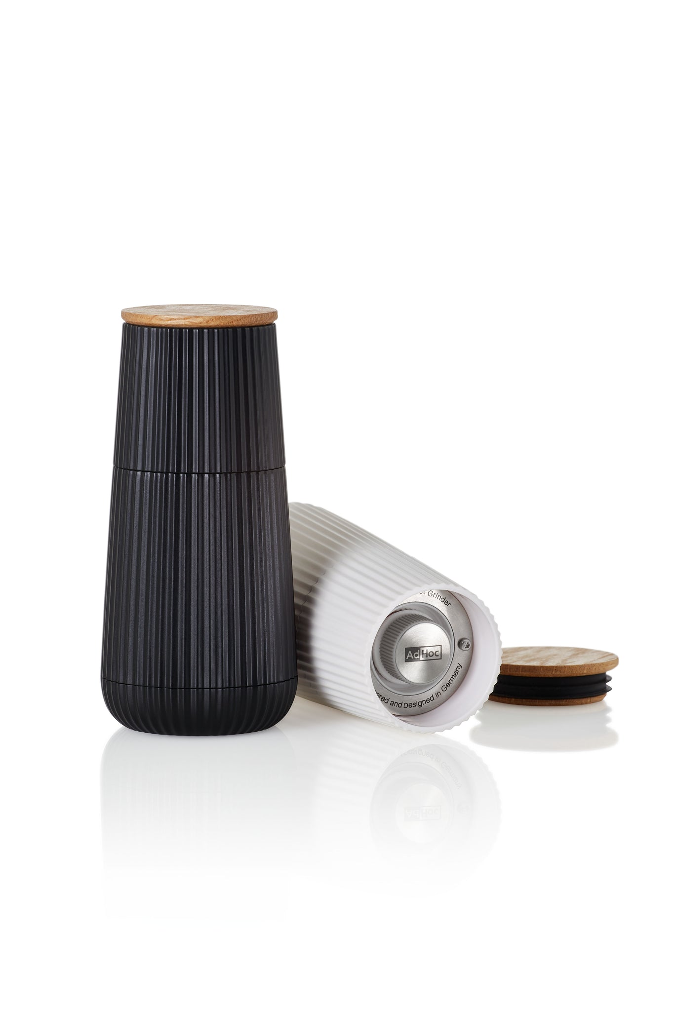 Sleek black ceramic container with a wooden lid and ribbed texture.