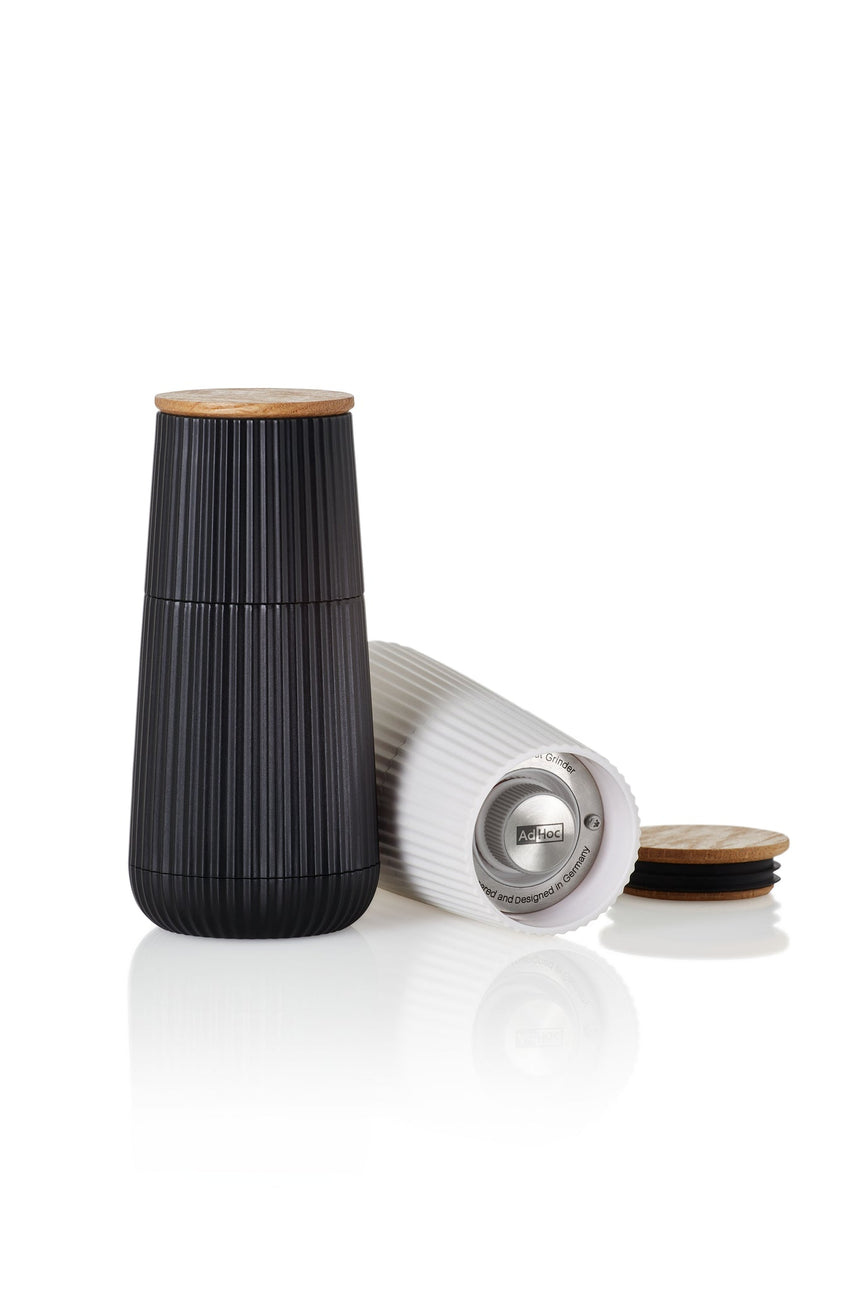Sleek black ceramic container with a wooden lid and ribbed texture.