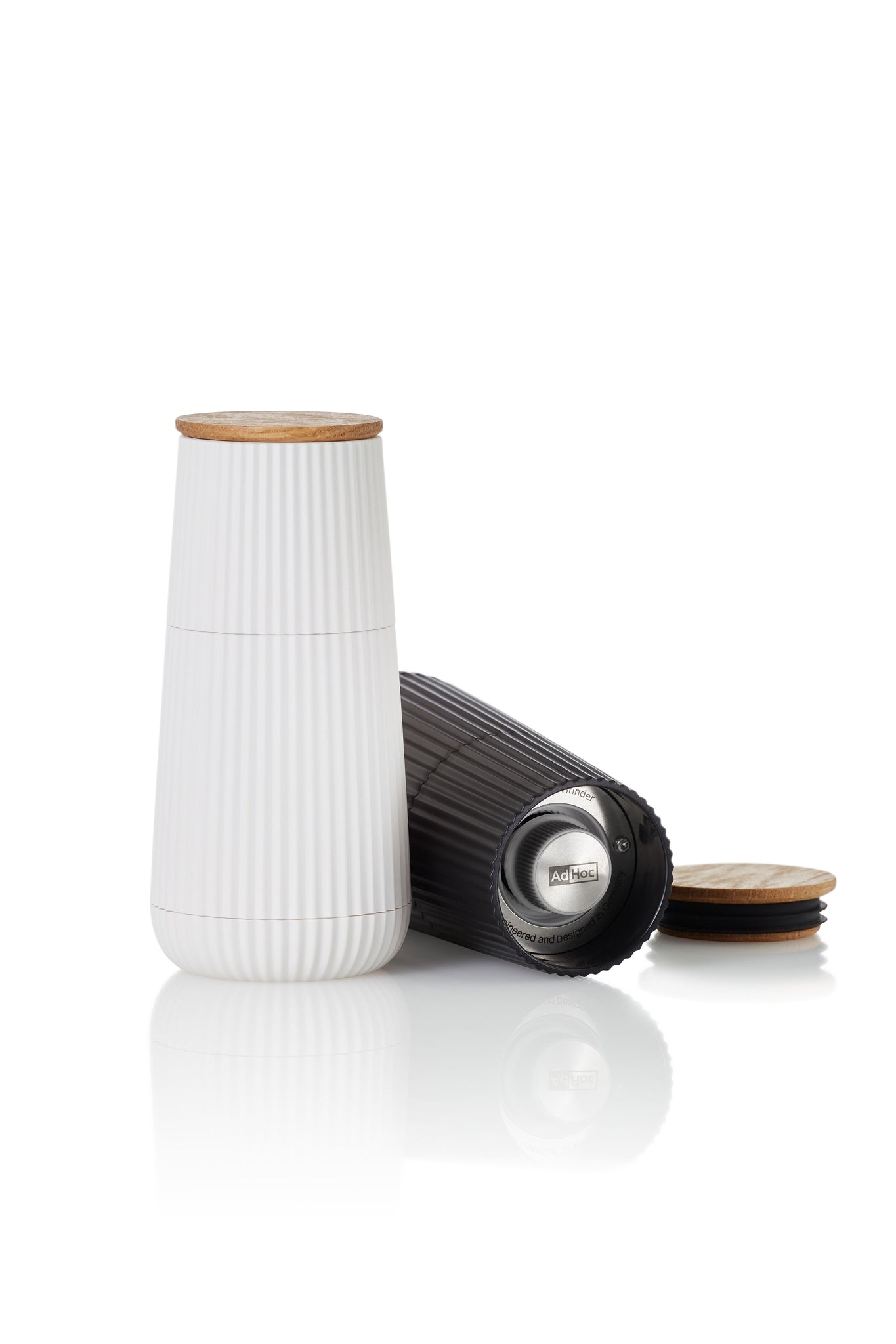 White ceramic container with a ribbed texture and wooden lid.