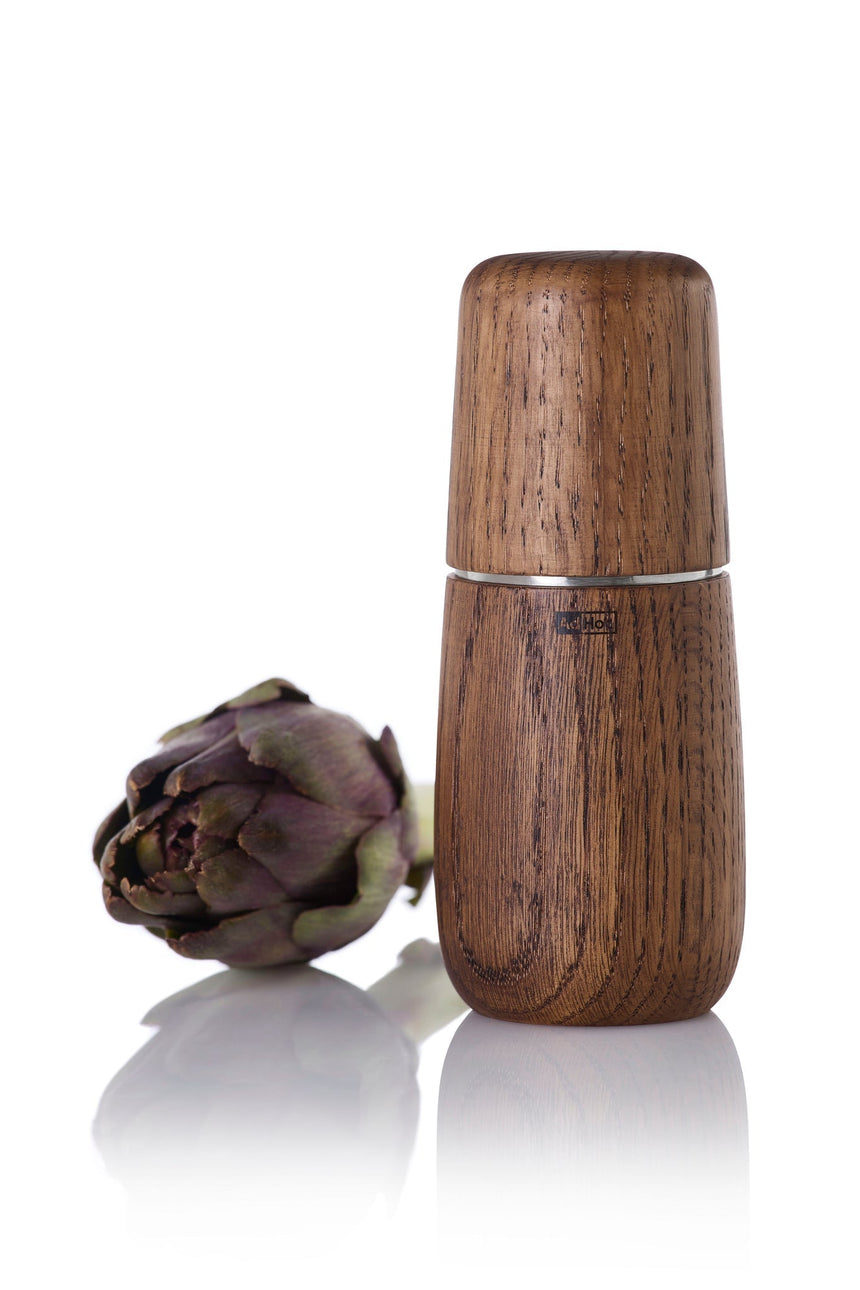 Wooden pepper mill or spice grinder with a smooth, cylindrical shape.