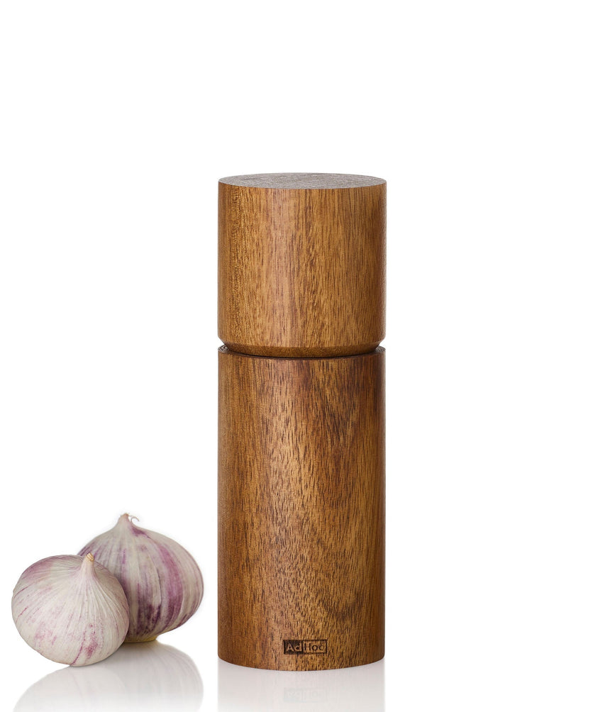 Wooden cylindrical pepper or salt mill with a twisting top section.