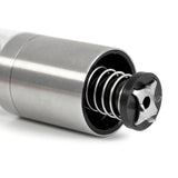 Stainless steel cylindrical device with an exposed internal spring mechanism.