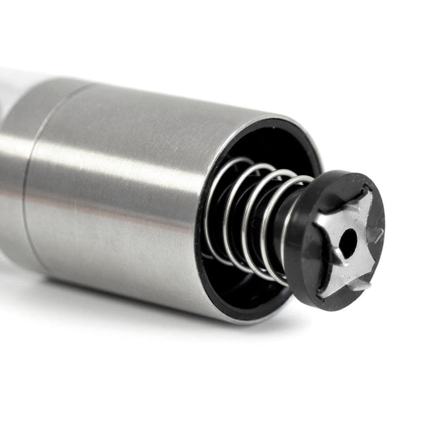 Stainless steel cylindrical device with an exposed internal spring mechanism.