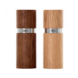 Two wooden pepper or salt mills with metal bands.