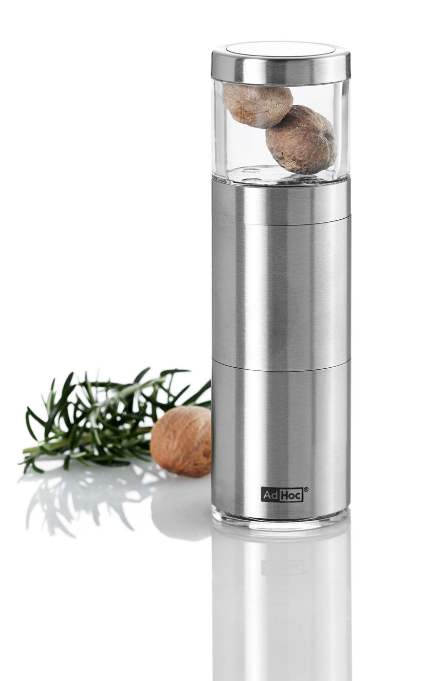 Stainless steel pepper mill with a clear glass chamber on top containing peppercorns.