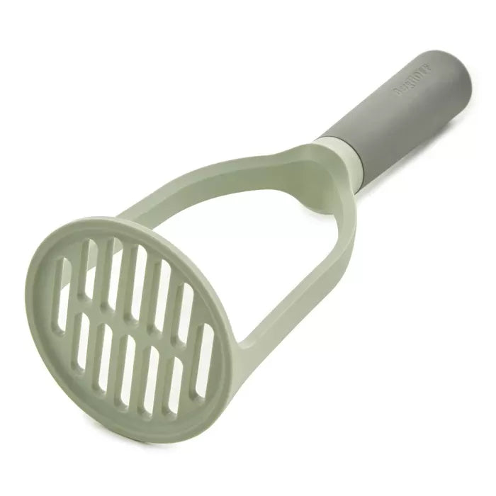Potato masher with a circular head and vertical slits.