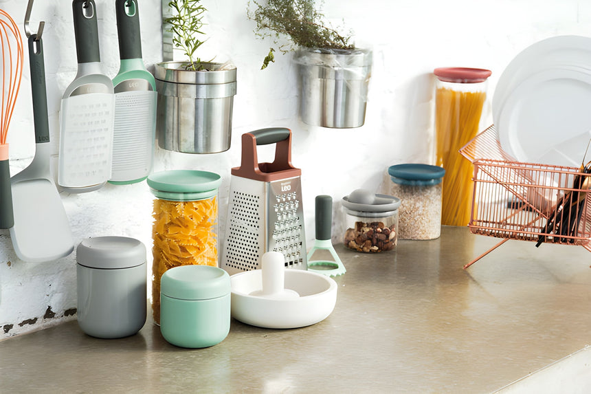 Collection of kitchen storage containers and utensils on a countertop.