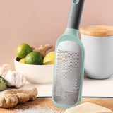 Mint-colored grater or zester with a long handle and perforated metal surface.