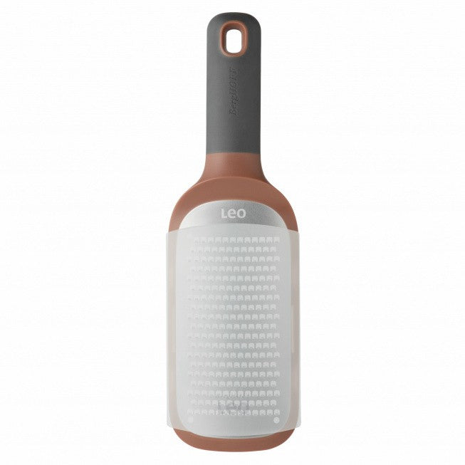 Bottle-shaped lint roller with a gray handle and copper-colored base.