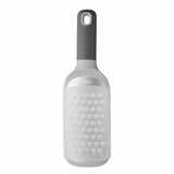 Cheese grater with a bottle-like shape and handle.