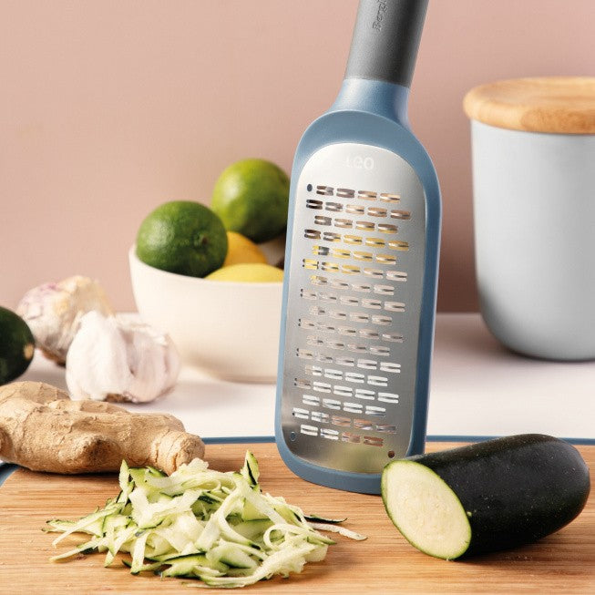 Blue-handled grater with a flat, elongated grating surface.