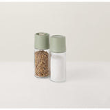 Salt and pepper shakers with pale green lids.