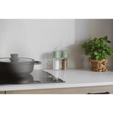 Gray cooking pot with a lid on a stovetop.