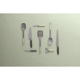 Collection of kitchen utensils and tools arranged neatly on a plain surface.