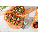 Bruschetta topped with tomatoes, herbs, and cheese on a wooden cutting board.